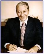 Image of ATF Director Rex Davis sitting at his desk preparing to sign a document