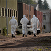 Image of technicians walking towards a building