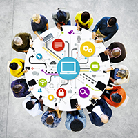Image of a group of people around a table using the same network