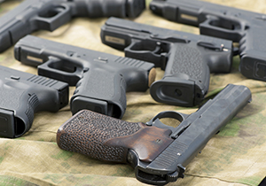 Image of different guns on a table