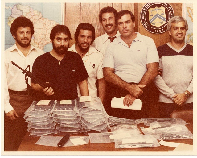 Special Agent Ariel Rios and other special agents posing next to seized evidence. Image of Special Agent Ariel Rios and other special agents posing next to seized evidence.