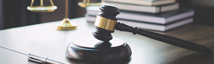 Image of a gavel, pen and justice scales