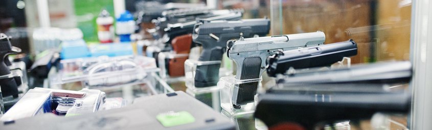 Row of pistols in a store display case