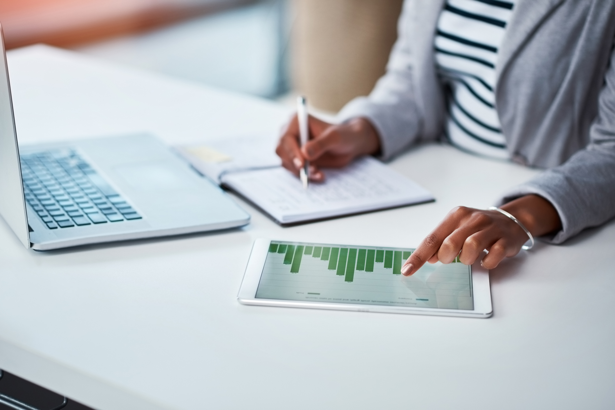 Woman with pen in her hand, reviews financial reports