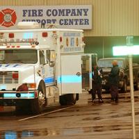 NRT members next to their vehicle outside a fire department