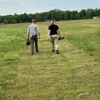 Sonia Melendez Moreno walking in a field with a colleague
