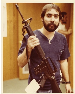Ariel Rios holding a firearm Image of Ariel Rios holding a seized firearm.